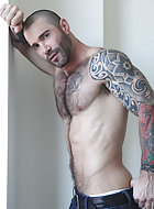 Jonathan Agassi’s next seedy sighting is none other than the burly hunk Junior Stellano seducing muscled sex-god Alexy Tyler. Alexy’s body is a sculpted work of art, and in no time at all, Junior turns him around, pulls down his pants, and worships hi